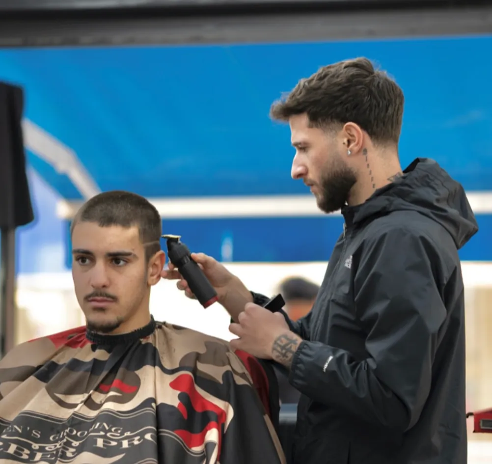 Mario cutting a client's hair